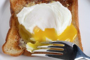 How Long to Poach an Egg - poaching egg on toast